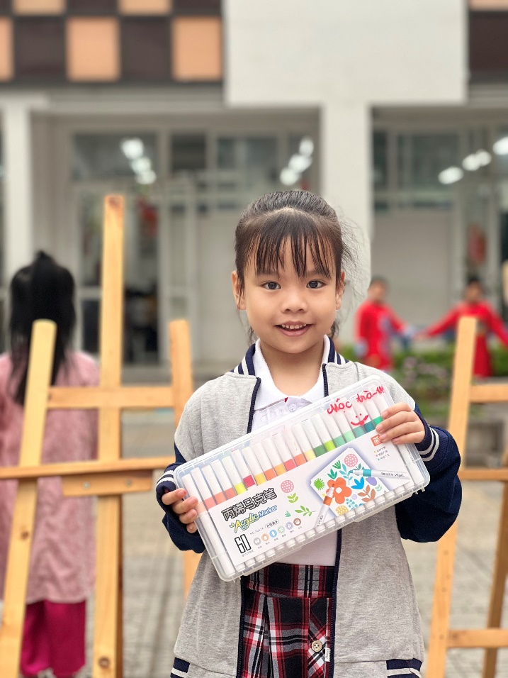 A child holding a box of markers

Description automatically generated